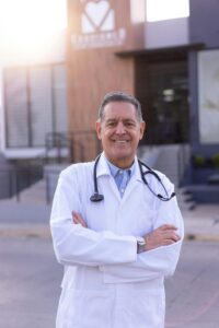 A doctor standing in front of a medical building